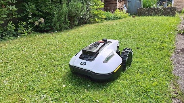 The Mammotion Yuka Mini robot lawn mower in tester's yard