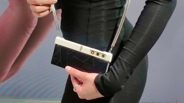 Honor V Purse worn by a women in a black dress