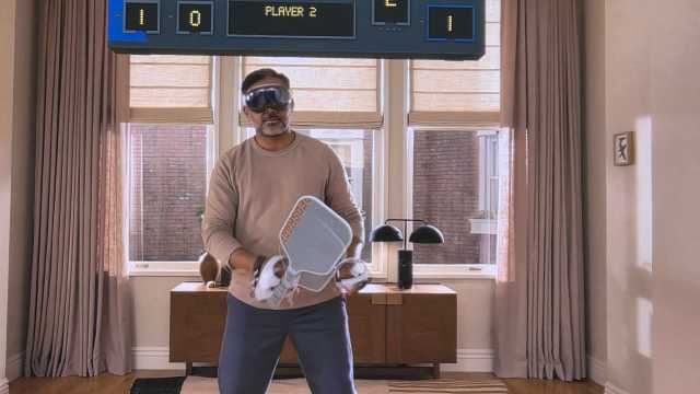 An Apple Vision Pro user with Sony Playstation VR controllers