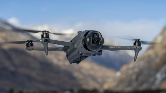 DJI Mavic 4 Pro drone in flight with snowcapped mountain backdrop