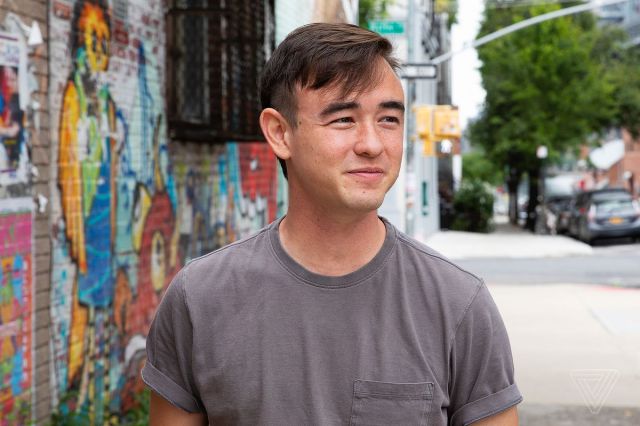 Portrait of a person standing on a city street.