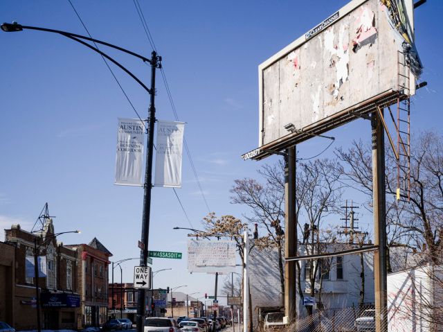 Workers dismantle a roof in Chicago westside Austin neighborhood.