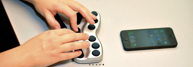 A person uses a Braillepen to access their phone