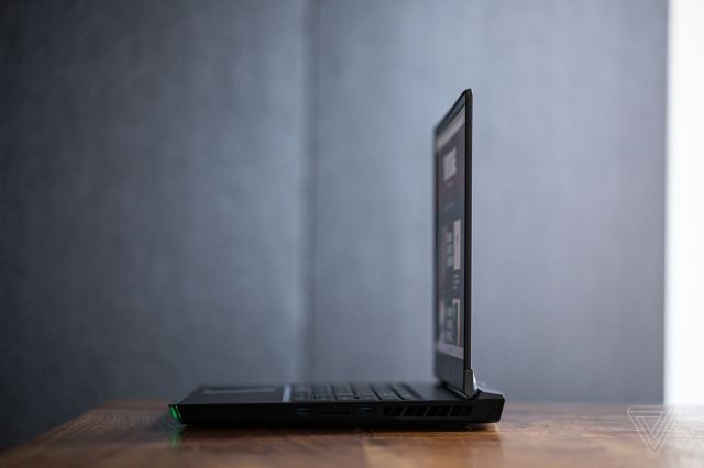The MSI GE76 Raider seen from the right on a wooden table.