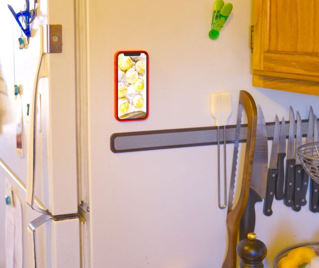 Picture of a phone magnetically stuck to the side of a refrigerator