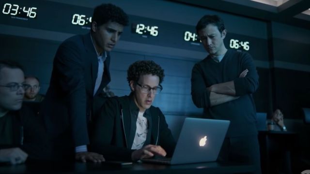 Emil, Quentin, and Travis looking at a laptop screen.