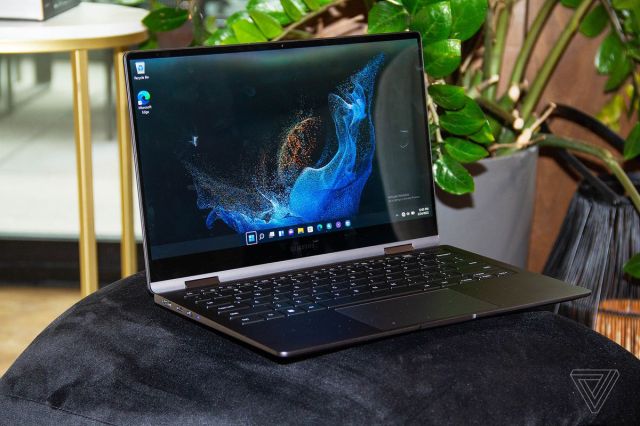 The Samsung Galaxy Book 2 360 on a black plus bench angled to the right. The screen displays a blue supernova on a black background.