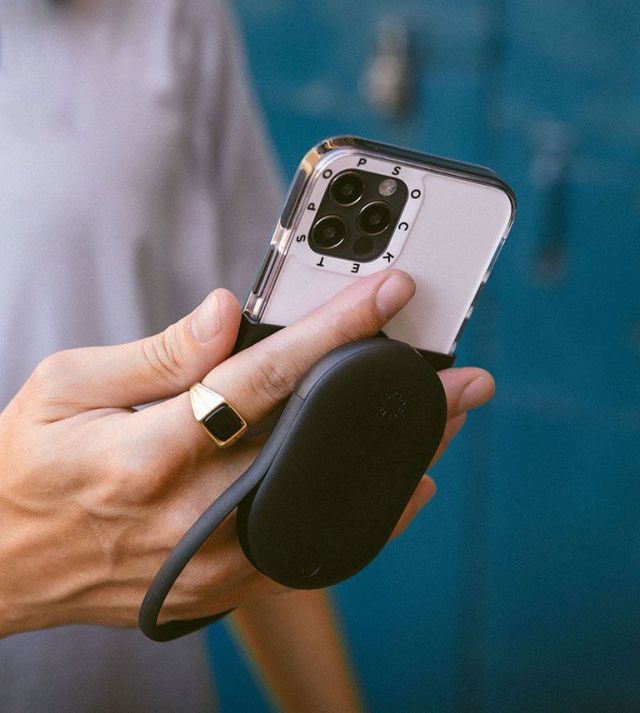 Image of someone using a PopGrip Jumpstart, and it covering three of their fingers.