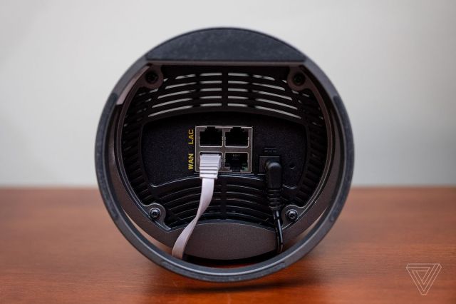 The underside of an Arris Surfboard Max Pro showing its four ethernet ports.