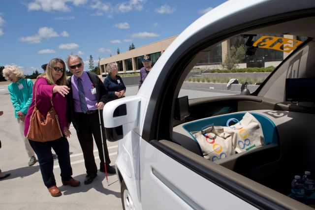 From background left, Judy Arvidson and Steve Mahan of the Santa Clara Valley Blind Center check out the two-seater prototype of Google’s self-driving car at Google in Mountain View, Calif., on Wednesday, May 13, 2015. (LiPo Ching/Bay Area News Group)