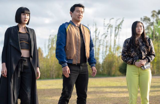 Xialing, Shang, and Katy look at something awkwardly in the distance.