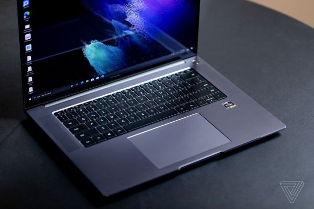 The Huawei MateBook 16 seen from above angled to the right side, open. The screen displays a blue and purple desktop background.
