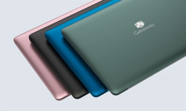 A stack of four Gateway laptops.