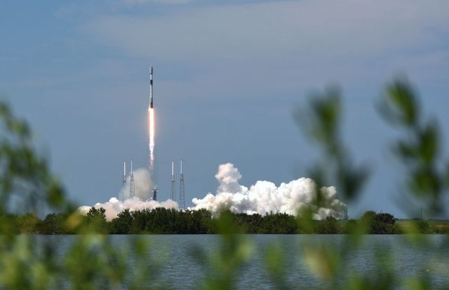 A SpaceX Falcon 9 rocket lifts off from pad 40 at the Cape...