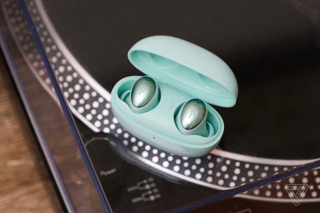 The 1More ColorBuds, the best budget wireless earbuds for style, pictured on top of a turntable.