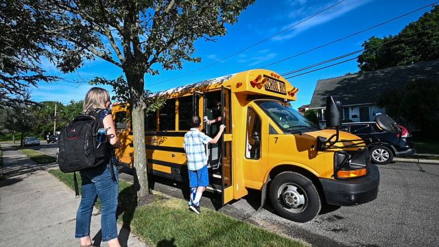 Student gets temperature taken before boarding school bus during pandemic