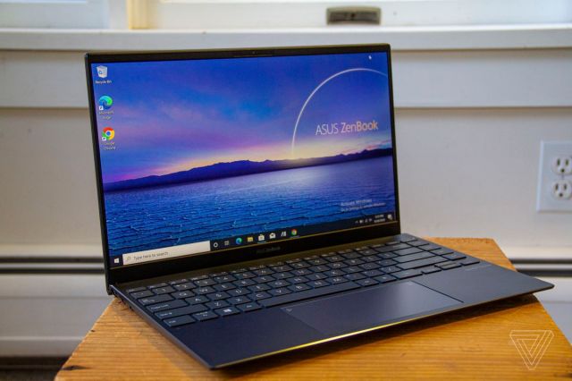 The Asus Zenbook 14 open on a crate at a slight angle to the right.