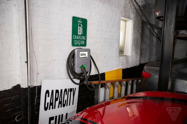 Electric vehicle charging stations in New York City are often inside paid parking lots. 
