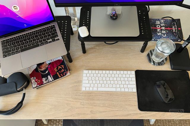top of desk with keyboard, mouse pad, laptop
