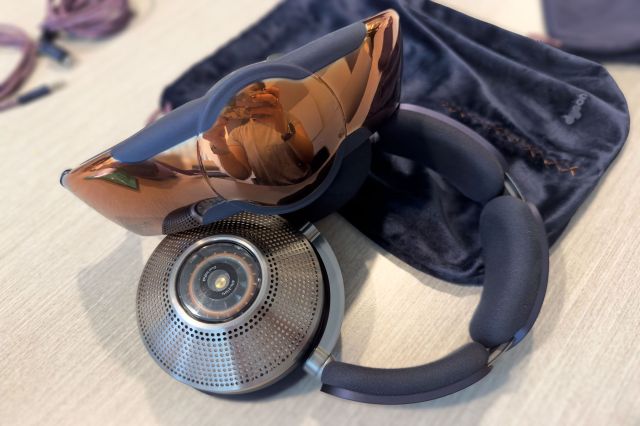 The Dyson Zone’s face visor sitting atop the headphones on a desk.
