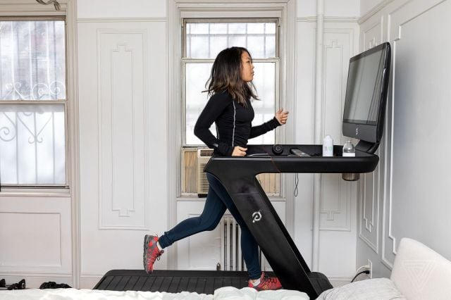 A runner trains on the Peloton Tread.