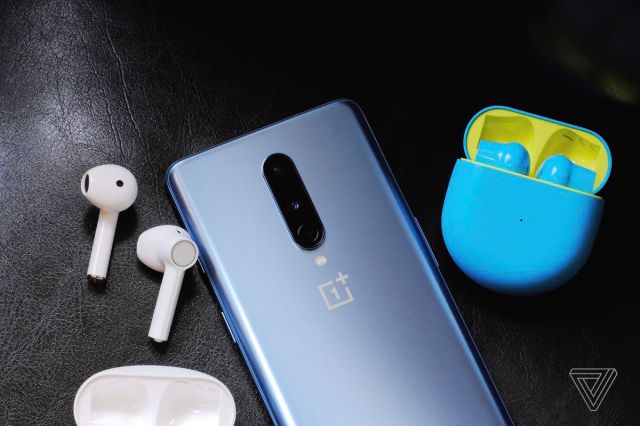 A photo of the white and blue/green OnePlus Buds.