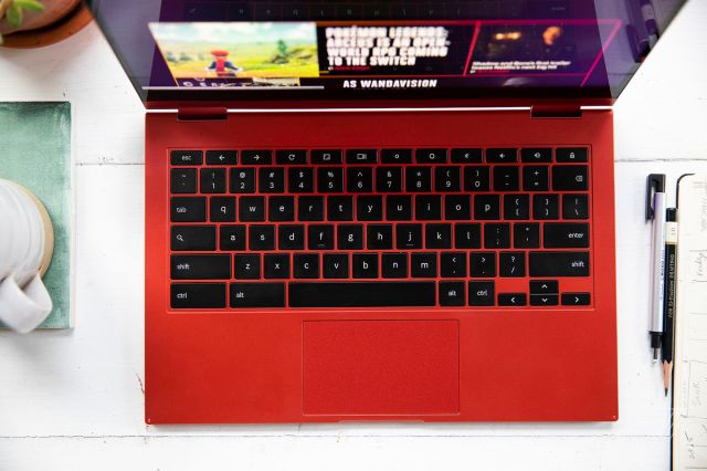 The keyboard of the Samsung Galaxy Chromebook 2 seen from above. A mug sits to its left on the desk, two pens and a ruler to its right.