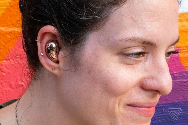 A photo of Samsung’s Galaxy Buds Live in someone’s ear.