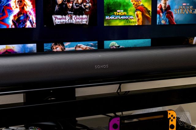 An image of the front of the Sonos Arc soundbar with a TV in the background.