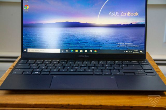 The Asus logo on the bottom bezel of the Asus Zenbook 14.