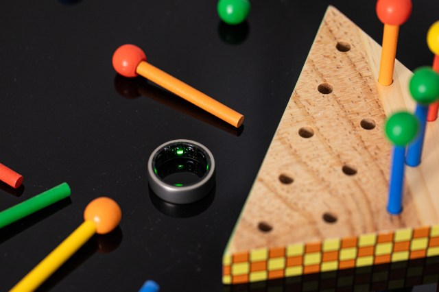 Amazfit Helio Ring with the sensor near colorful wooden toys