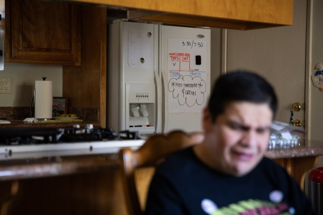 Mark sitting in a chair with the kitchen behind him.