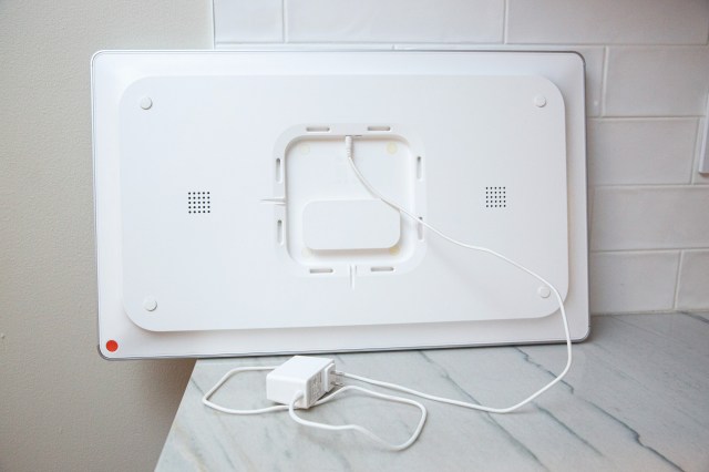 The rear of the Cal Max. The orange button is a power button, there are two speakers and a built-in wall mount which fits on to an included bracket. The 6-foot power cable is attached by a barrel plug.