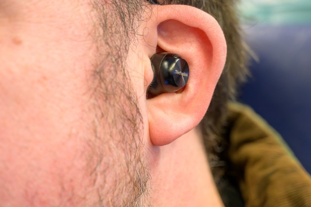 A photo of the Technics AZ100 earbuds in a person’s ear.