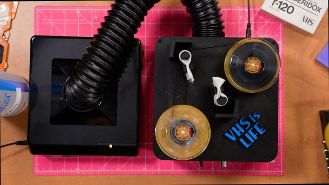 Top down photo of the VHS cleaner. The right spool has the tape cleaned. The empty spool on the left has mold residue.