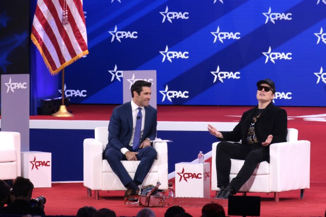 Rob Schmitt and Elon Musk onstage at CPAC 2025.