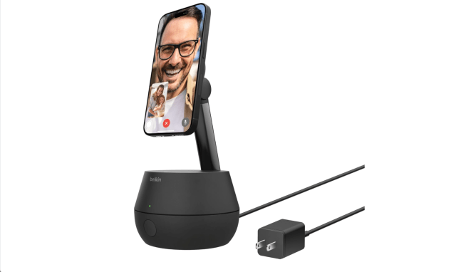 Phone stand with phone attached showing face.