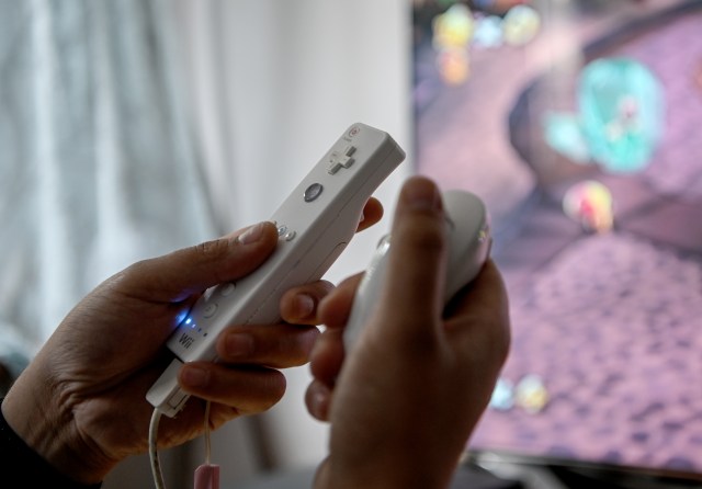 02 April 2020, Berlin: A young man is playing with the game console Wii. To prevent infection with the corona virus, many people spend their free time at home