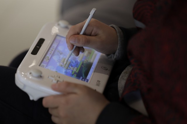 A visitor plays Nintendo Co.’s Super Mario Maker video game using a stylus on the company’s Wii U game console controller at the Nintendo Game Front showroom in Tokyo, Japan, on Thursday, Dec. 22, 2016. 
