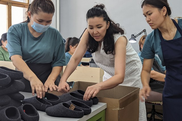 Staff in one of the rooms in Tumar’s Bishkek factory, evaluating a finished batch of Kyrgies “wool slide” slippers.