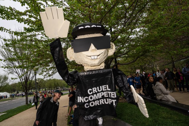 A demonstrator holds a model figure of Elon Musk during a protest on the National Mall in Washington, DC, US, on Saturday, April 5, 2025. “Hands Off” protests against Trump administration policies are happening in more than 1,000 cities and towns across the country today.