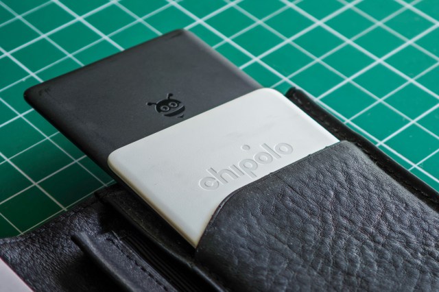 A Pebblebee Card and Chipolo Card sticking out of a wallet