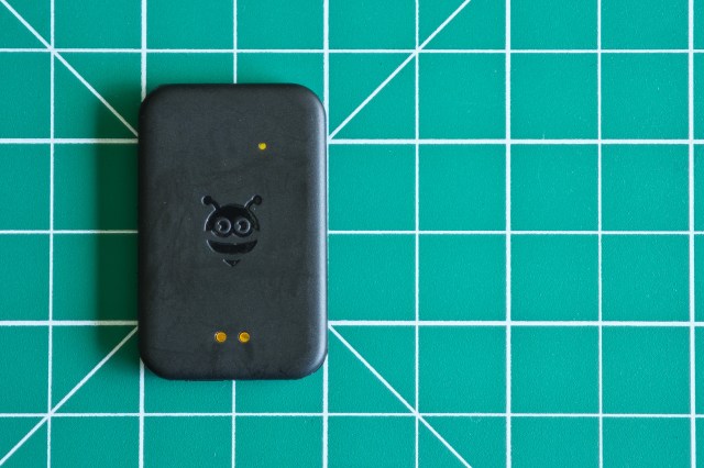 The Pebblebee Tag tracker on a green gridded table