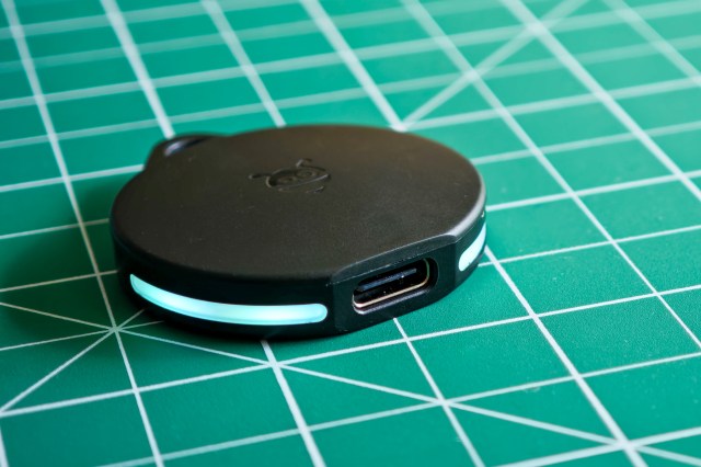 A Pebblebee Clip tracker with the light on