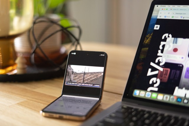 Photo of Motorola Razr Ultra on a table with inner screen folded halfway.