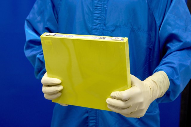 An employee holds a full-size prototype LMR battery cell at the General Motors Wallace Battery Cell Innovation Center.