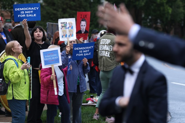 Activists staged an “America Is Not For Sale” protest while President Trump hosted the winners of his meme coin contest at the Trump National golf club.