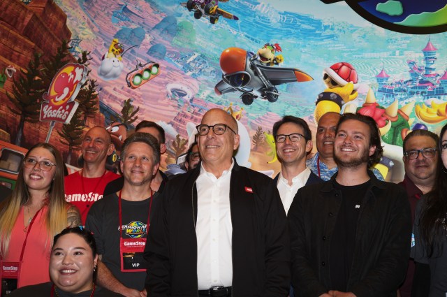 Doug Bowser (center) poses with Gamestop staff.