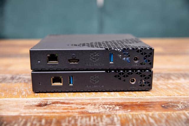A closeup of the back connections on the Kaleidescape Strato E and Mini Terra Prime server, stacked on a wooden table.