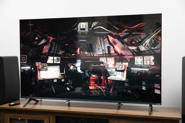 The Vizio Mini LED Quantum displaying an image from The Expanse, sitting on a wooden credenza.